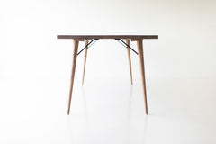 Distressed dining table styled in a bright dining room