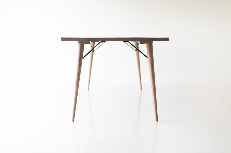 Distressed dining table styled in a bright dining room