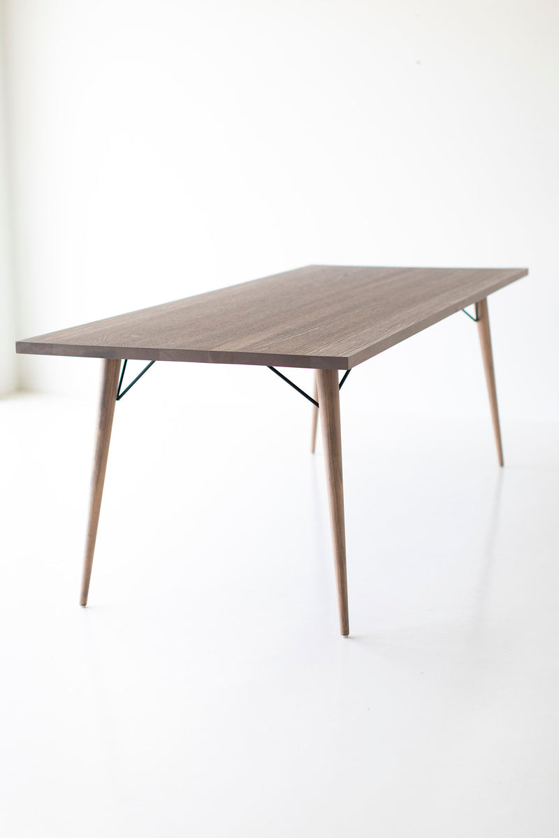 Angled view of the distressed dining table showcasing its proportions