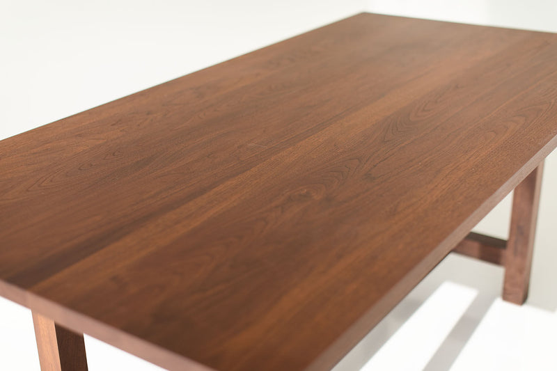 Modern luxury walnut farm table styled in a dining room