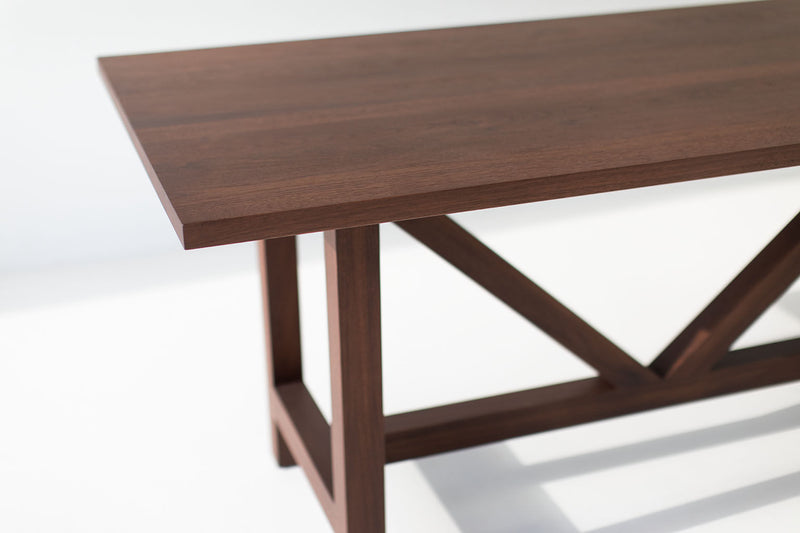 Angled view of the modern luxury walnut farm dining table