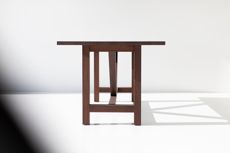 Detail of the hand-perfected matte finish on the modern walnut tabletop