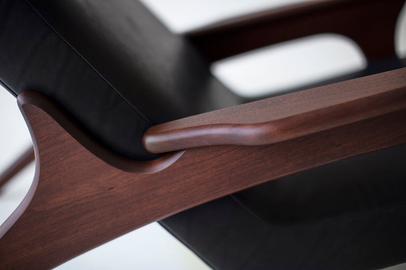 Close-up of the high-grade black leather and stitching on a lounge chair