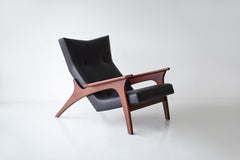 Angled view of a Frank lounge chair showing its hardwood frame construction