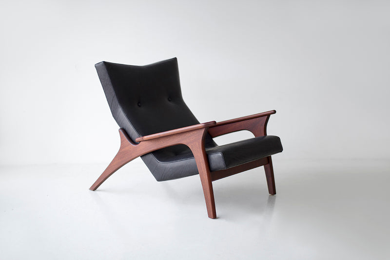 Angled view of a Frank lounge chair showing its hardwood frame construction