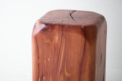 Softly angled, sculpted corners of the cedar stool