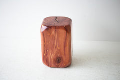 Modern luxury cedar stool styled on an outdoor patio