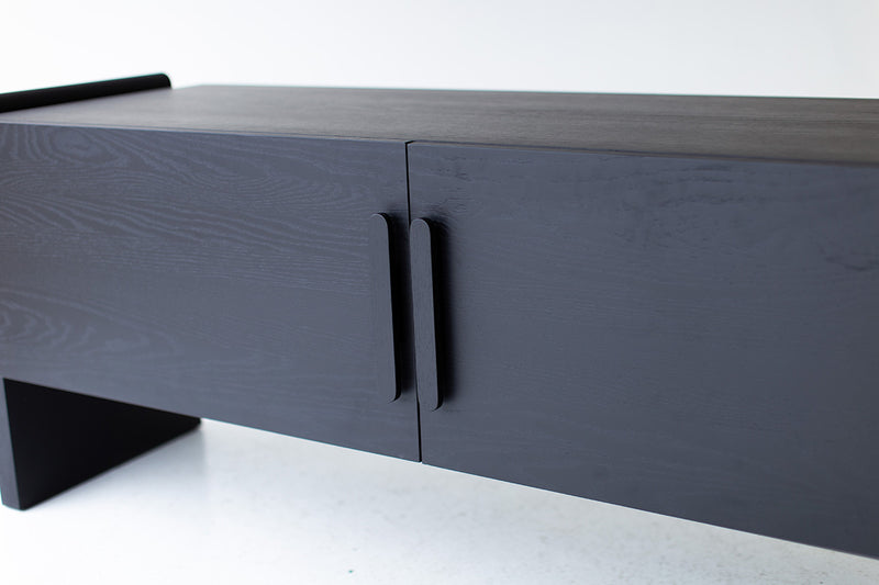 Black oak credenza styled against a wall in a modern living room