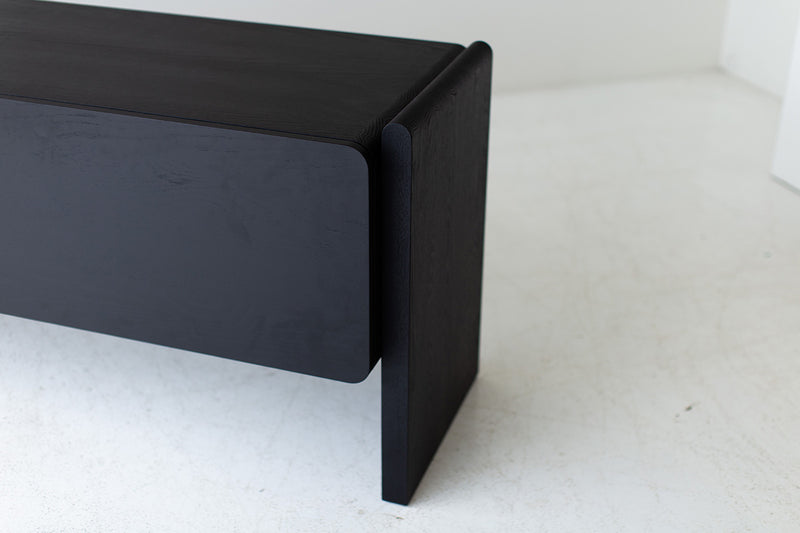 Black credenza used as a media console beneath a television