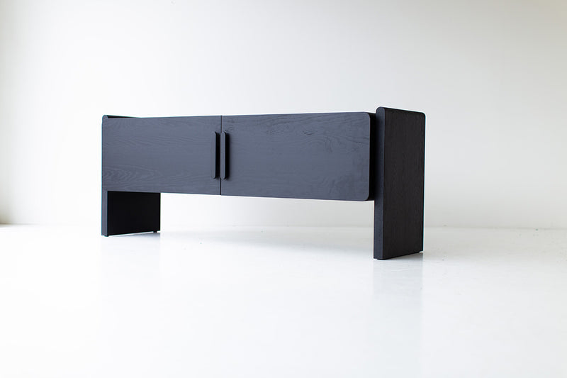 Organic modern black credenza in a bright, airy interior