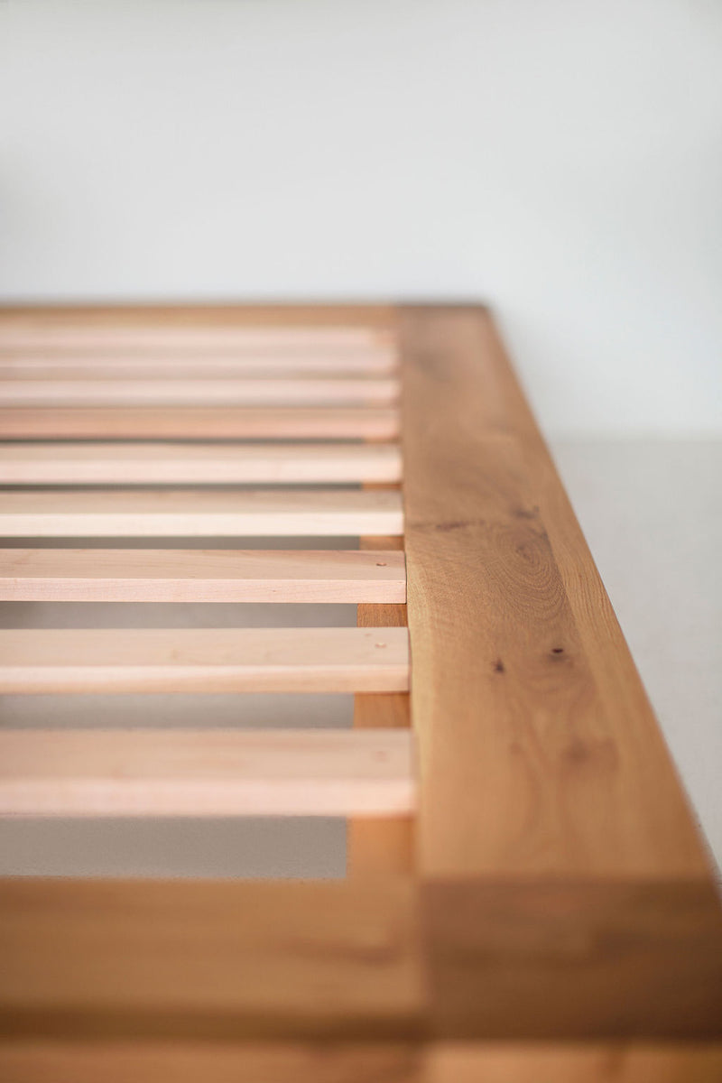 Detail of the joinery on a rustic white oak platform bed frame