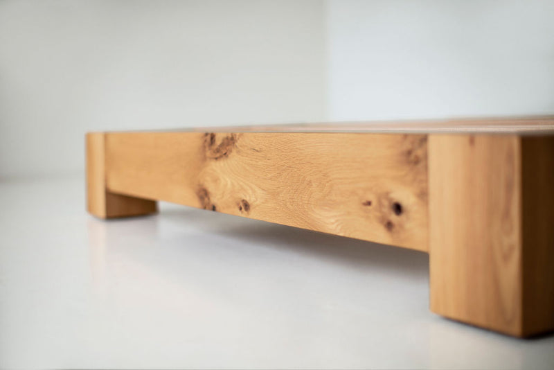 Full view of a white oak platform bed against a white backdrop