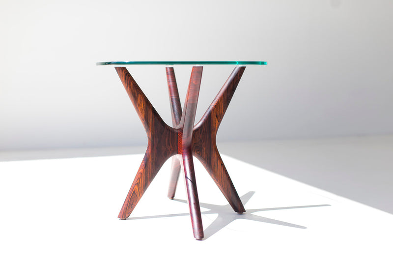 Close-up of the hand-shaped walnut legs on the Jax side table