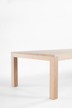 Front view of the Christopher table showing its bleached oak top