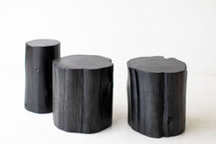 Black tree stump side tables grouped together as a coffee table