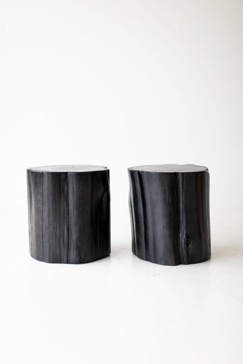 Angled view of the black tree stump side table showcasing its texture