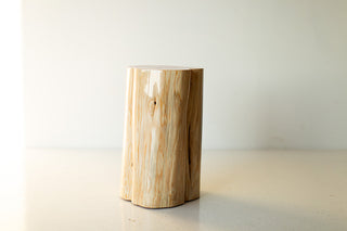 Close-up of the natural finish on the red cedar stump table showing wood grain
