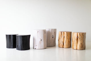 Natural wood stump tables grouped together as a coffee table
