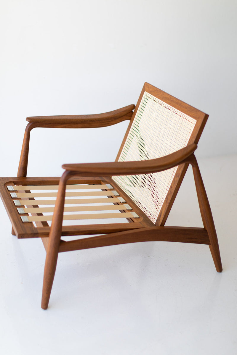 Modern luxury cane back teak lounge chair styled in a modern living room