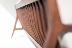 Close-up of the walnut wood grain on the sofa arm