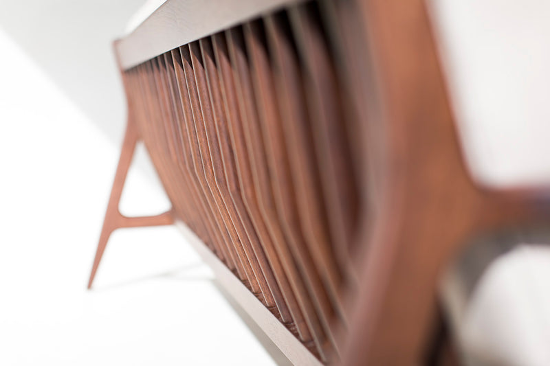 Close-up of the walnut wood grain on the sofa arm
