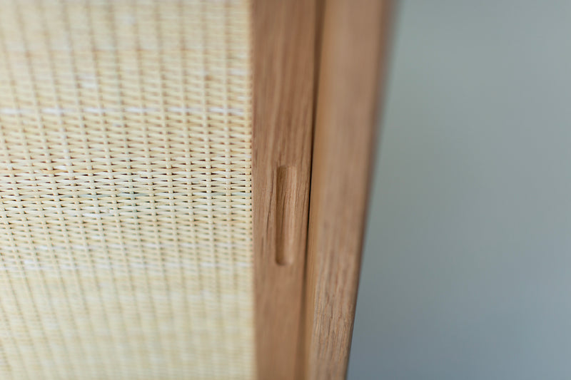 Modern oak cabinet styled with decor and books on top