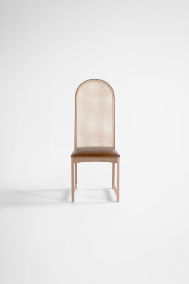 Side profile of the Milo Baughman dining side chair highlighting its high arched back