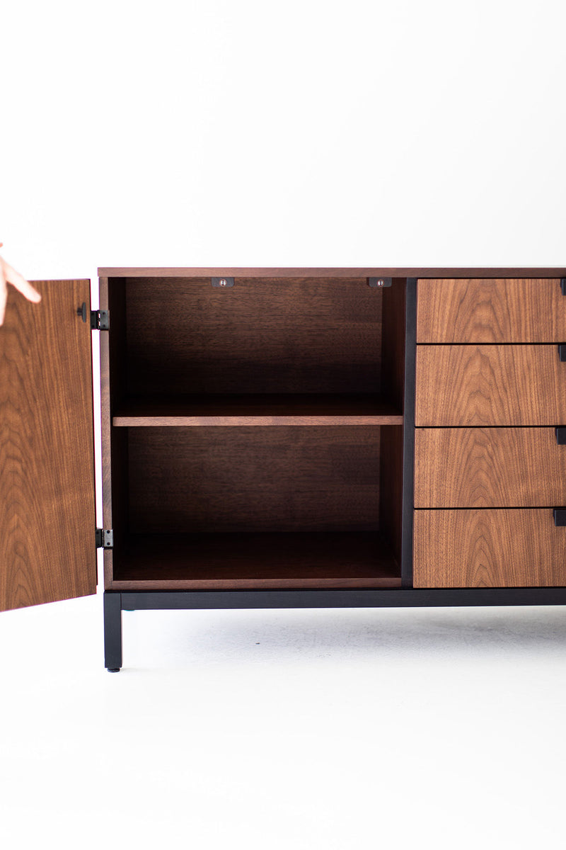 Modern walnut buffet styled with decor and artwork above