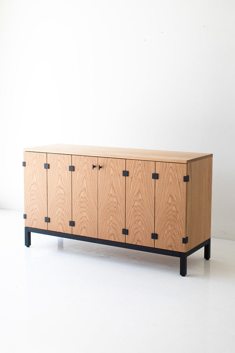 Front of the credenza showing flat door fronts, slim pulls and tapered legs