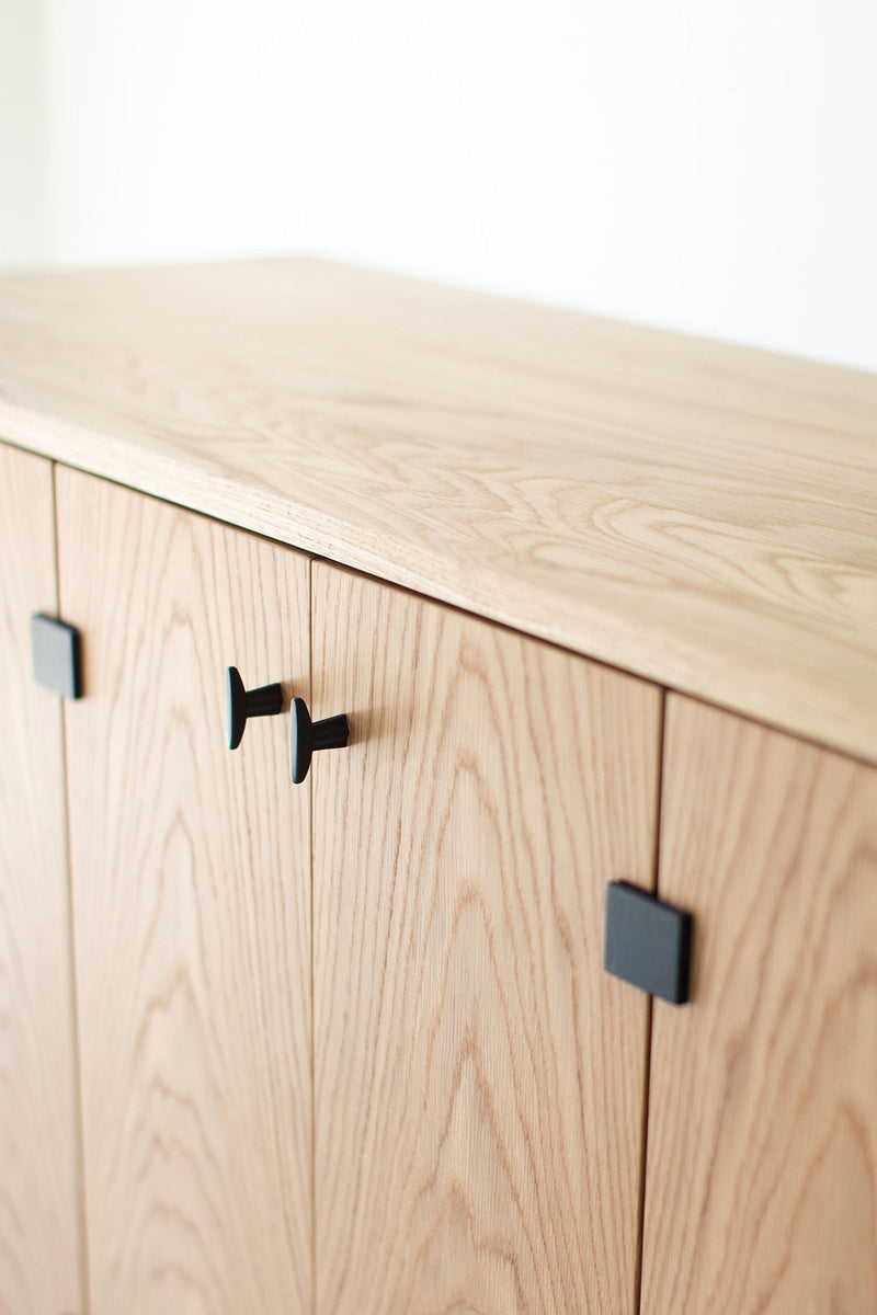 Side angle of the credenza highlighting its low profile and wood grain