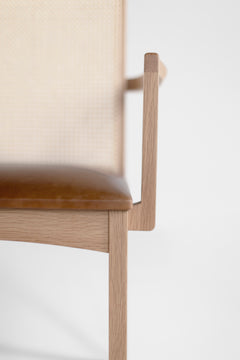 Angled view of the oak dining arm chair showing its clean modern lines
