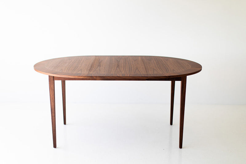 Modern luxury round dining table by Milo Baughman in solid walnut and rosewood