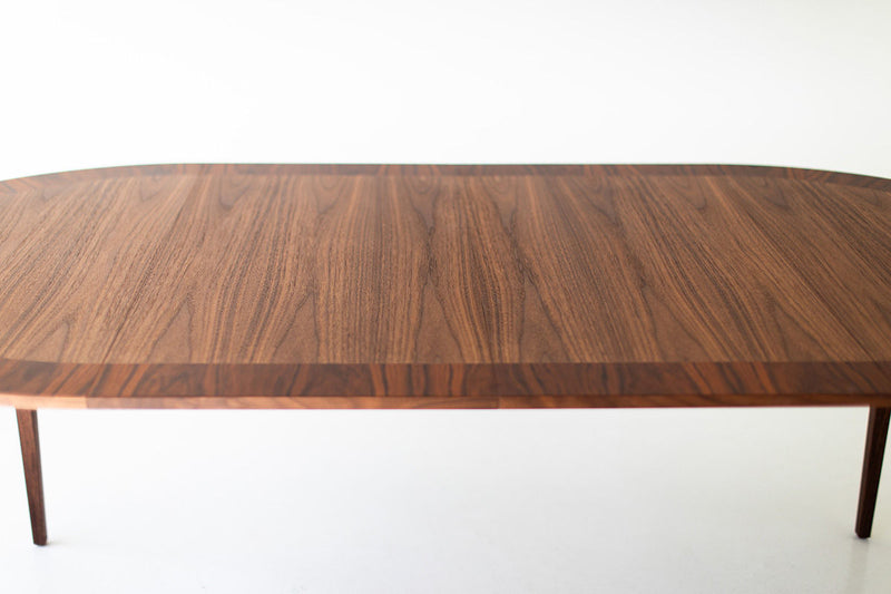 Angled view of the round table's walnut and rosewood grain