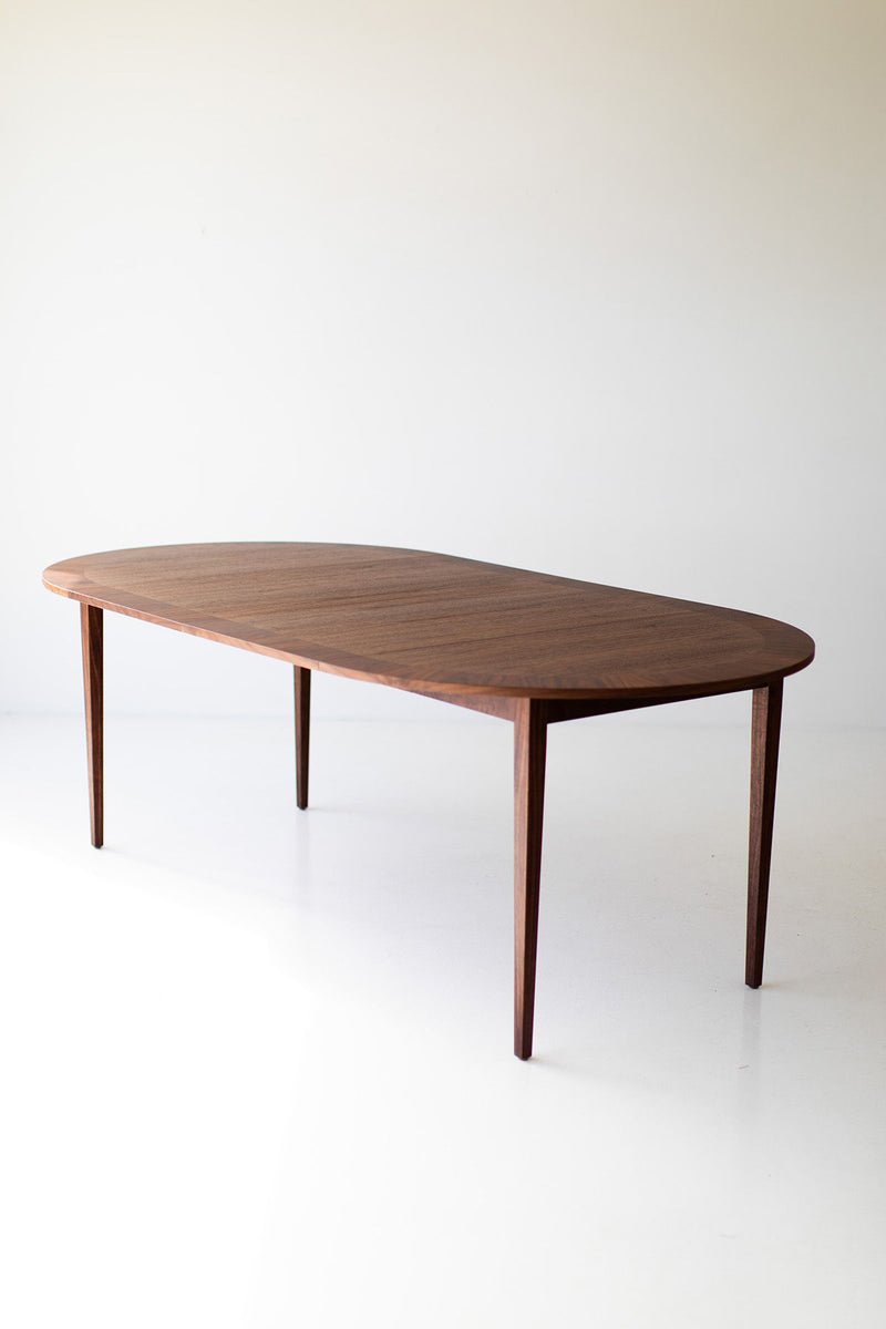 Full view of the Milo Baughman round dining table against a neutral backdrop