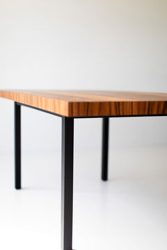 Side profile of the striped top dining table showing its base