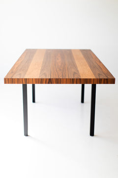 Modern luxury striped top walnut dining table styled in a dining room