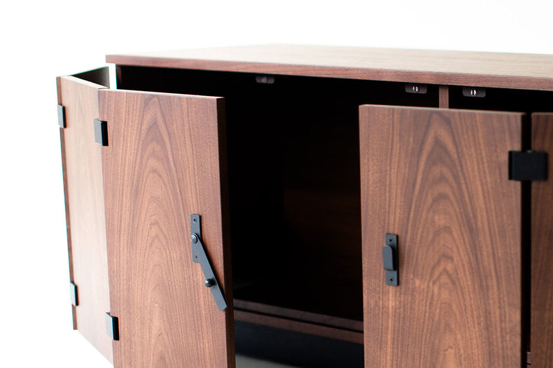 Side profile of the walnut sideboard showing its low silhouette