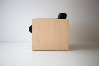 Mondo maple lounge chair in black thick weave fabric shown at an angle, highlighting its low, chunky silhouette