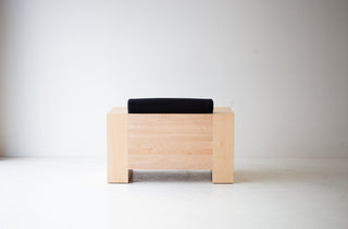 Side profile of the solid maple Mondo lounge chair with black thick weave fabric