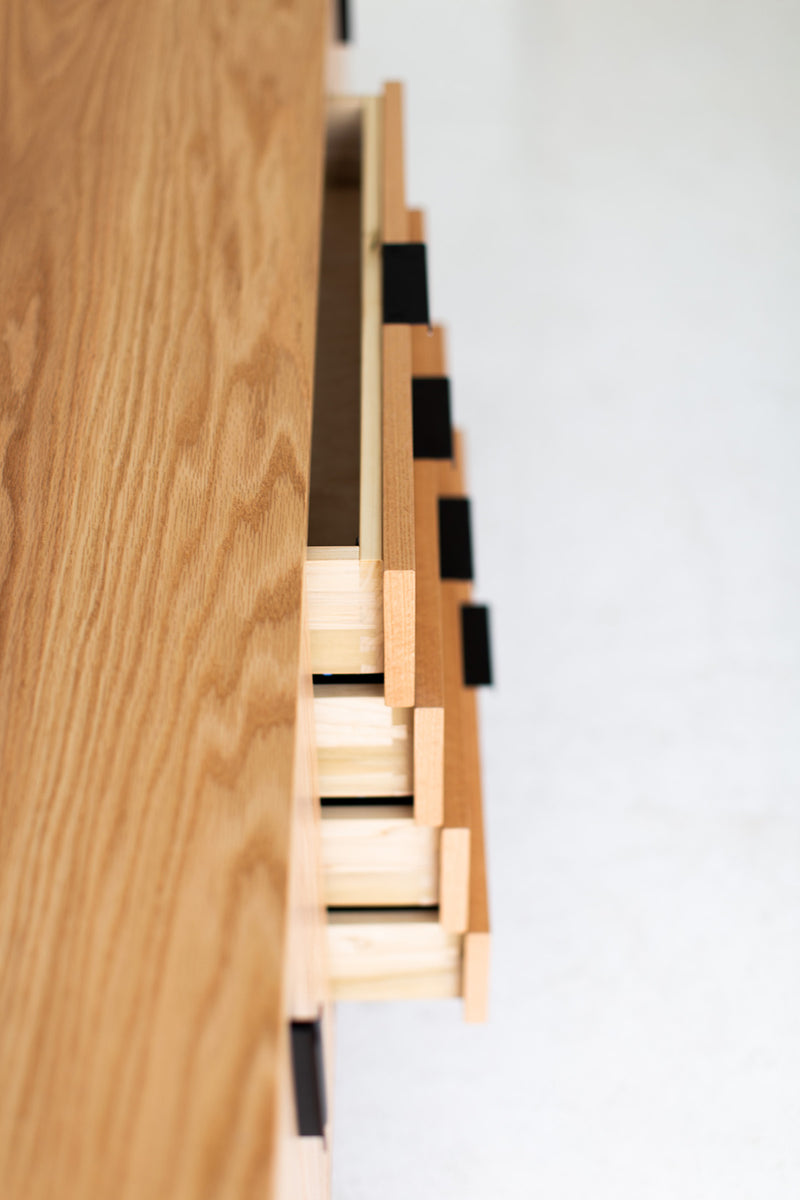 Modern luxury oak credenza styled along a home office wall