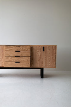 The credenza styled with objects and art above it