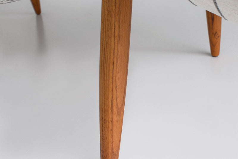 Side profile of the outdoor chaise lounge showing its low, sculptural silhouette