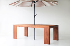 Angled view of a slatted top dining table showing its modern leg design