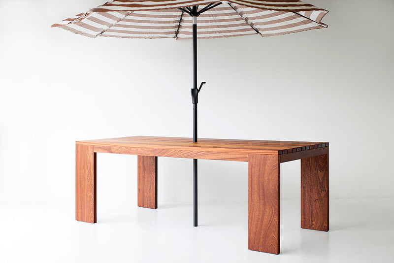 Angled view of a slatted top dining table showing its modern leg design