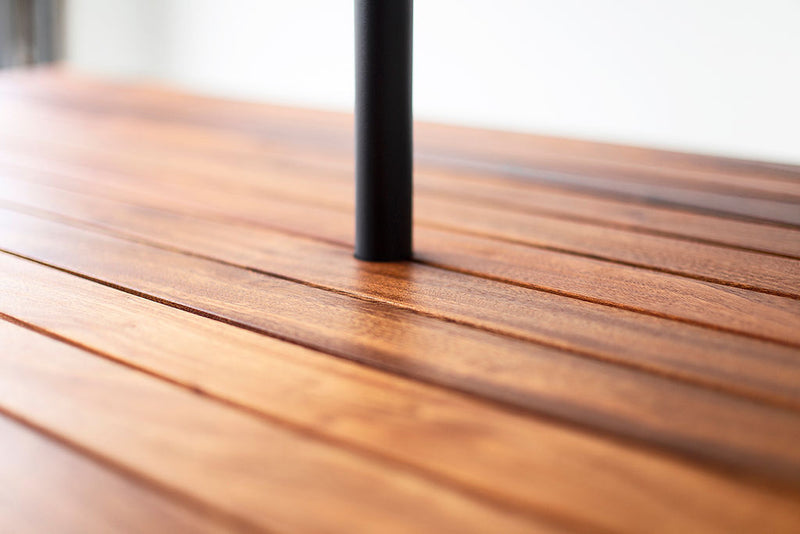Detail of the wood grain and slatted joinery on a dining table top