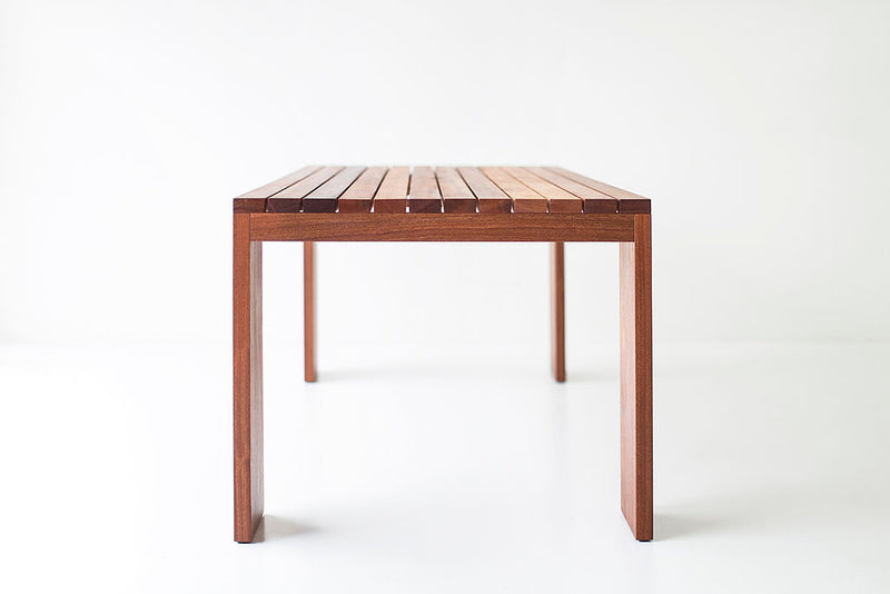 Full view of a Chile slatted top dining table against a white backdrop
