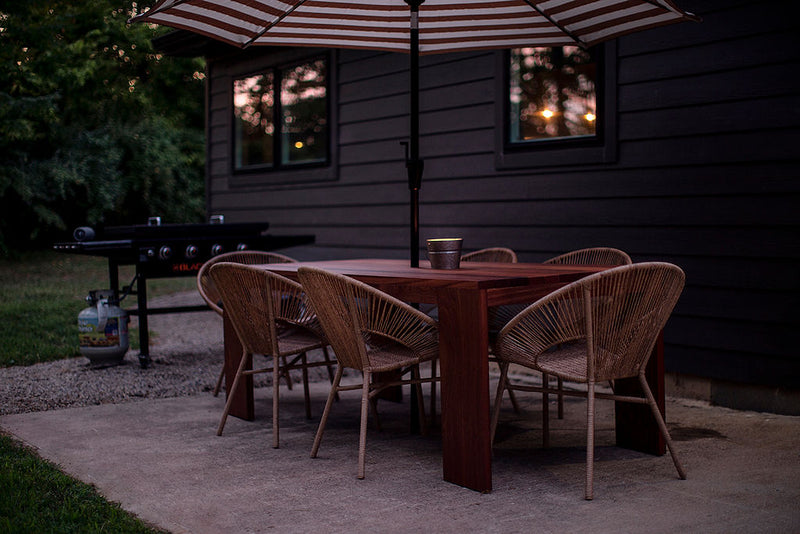 Slatted dining table styled outdoors with place settings