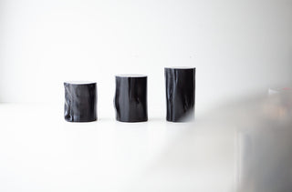 Natural wood grain and character cracking on a black stump table