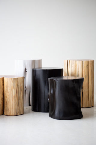 Black stumps grouped together as a modern coffee table