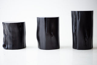 Black modern stump side table styled in a bright living room